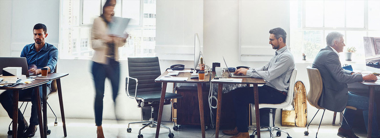 Office photography NYC — staff working at desks in a loft office